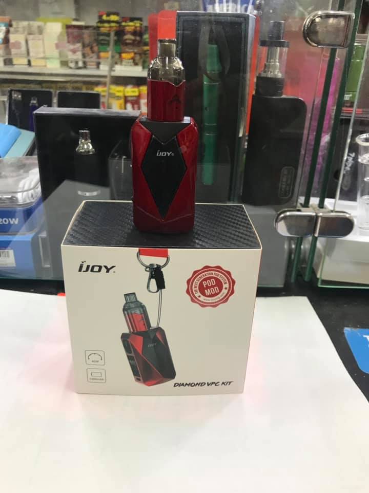 IJOY Diamond VPC kit. Red/black vape on box. Store display with other vape products visible in background.