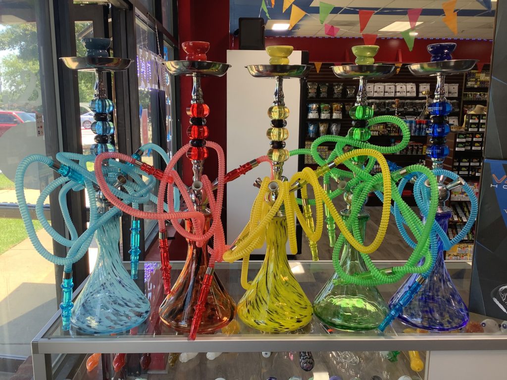 Four portable hookahs displayed in a store