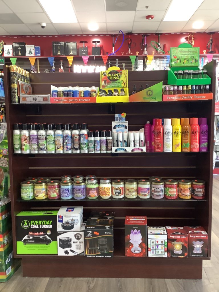 A store shelf filled with lots of different tobacco products